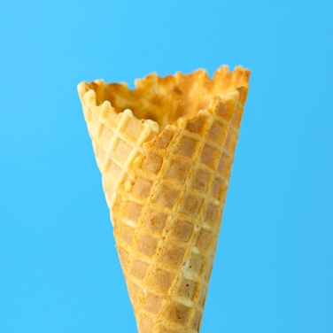 empty waffle cone on blue background