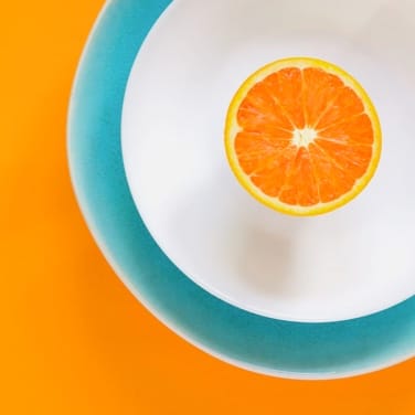 orange on blue and white plate on orange background