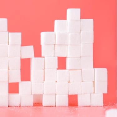 sugar cubes stacked on pink background